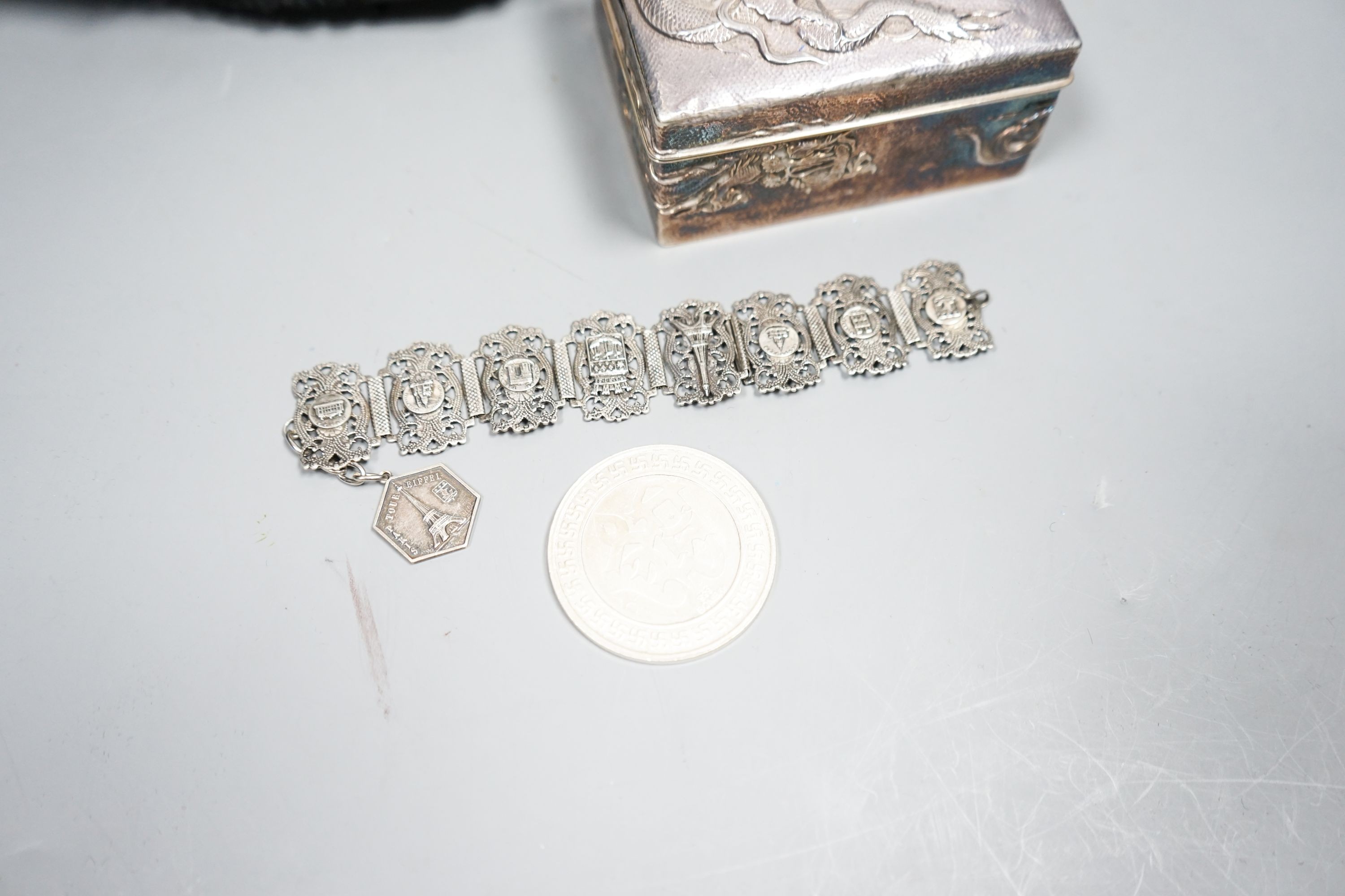 A Japanese silver box, bracelet, medal and military cap